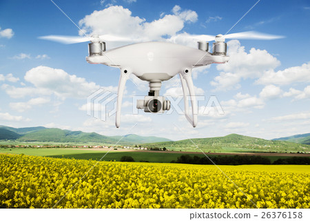 Hovering drone taking pictures of canola field and 26376158
