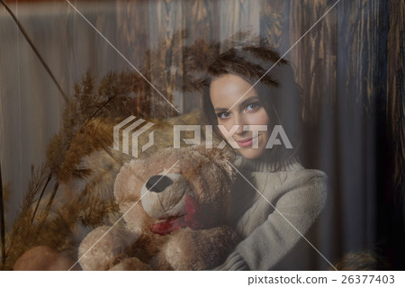 Cute girl in warm knee socks and sweater with Teddy bear in her Cute girl in warm knee socks and sweater with Teddy bear in her 26377403