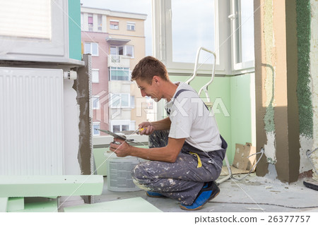 Plasterer renovating indoor walls and ceilings 26377757
