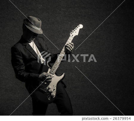 Musician playing the guitar on dark background,music concept 26379954