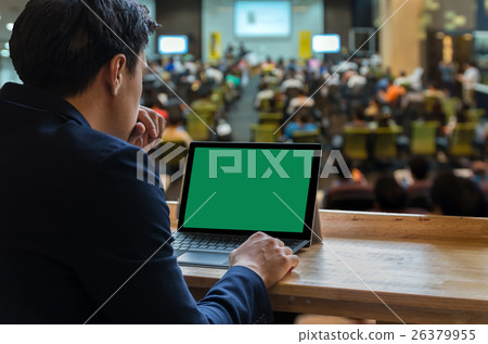 Businessman sitting and using computer laptop showing the blank green screen over the Meeting Blurred background at bright conference hall, Business meeting concept Businessman sitting and using computer laptop showing the blank green screen over the Meeting Blurred background at bright conference hall, Business meeting concept 26379955