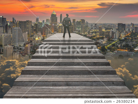 Businessman climbed on top of the stairs which can see top view of cityscape over the clouds background ,Success business and Ambitions concept Businessman climbed on top of the stairs which can see top view of cityscape over the clouds background ,Success business and Ambitions concept 26380214