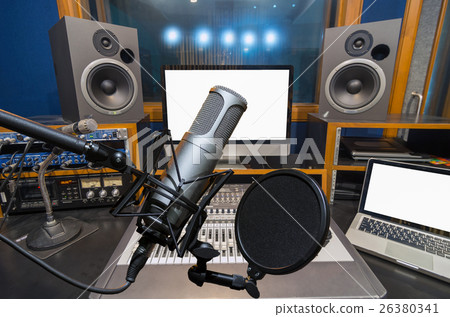 Professional condenser studio microphone over the music studio background, Musical instrument Concept Professional condenser studio microphone over the music studio background, Musical instrument Concept 26380341