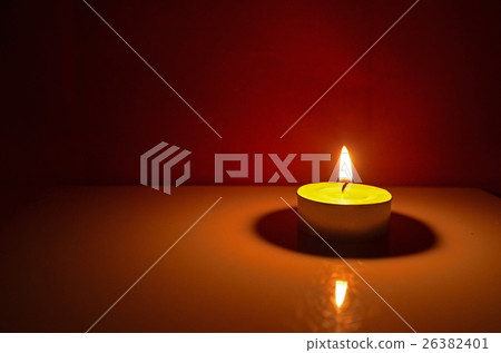 Light of yellow candle with red scene Light of yellow candle with red scene 26382401