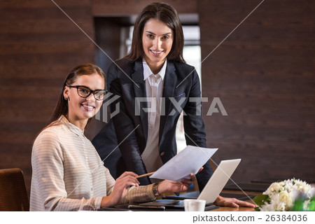 Beautiful colleagues posing in their office. Beautiful colleagues posing in their office. 26384036