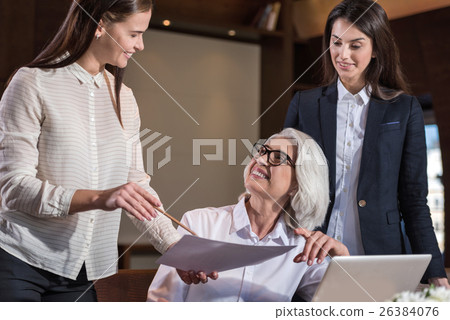 Female colleagues discussing their work with boss Female colleagues discussing their work with boss 26384076