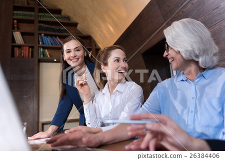 Three delighted colleagues doing their job Three delighted colleagues doing their job 26384406