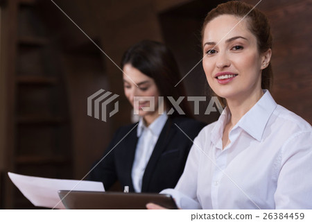 Beautiful colleagues posing during the workday in 26384459