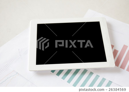 Digital tablet on stock and finance graph papers 26384569