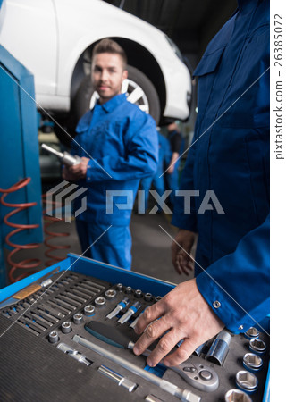 Professional car mechanic choosing a tool 26385072