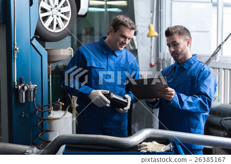 Positive mechanics standing in auto service. 26385167