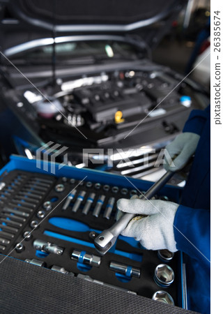 Professional mechanic holding wrench Professional mechanic holding wrench 26385674