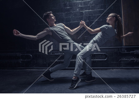 Involved dancers warming up in close interaction 26385727