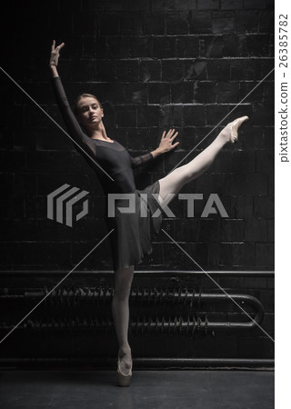 Charming dancer training near the black wall 26385782