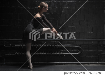 Involved young dancer training near the dark wall 26385783