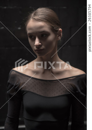 Concentrated dancer standing in the dark room 26385794