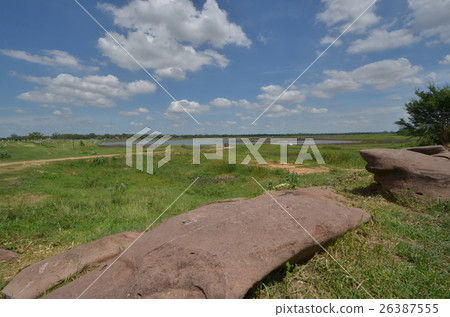 Brown sandstone and grass under beautiful cloudy s Brown sandstone and grass under beautiful cloudy s 26387555