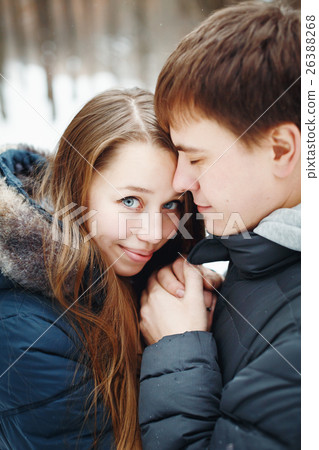 Couple in love having fun in winter forest 26388268