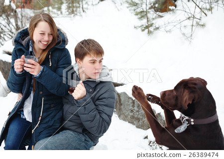 Couple drinking hot drink outdoors 26389474