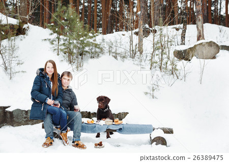 Couple drinking hot drink outdoors Couple drinking hot drink outdoors 26389475