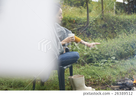 A woman holding her hand on a bonfire A woman holding her hand on a bonfire 26389512