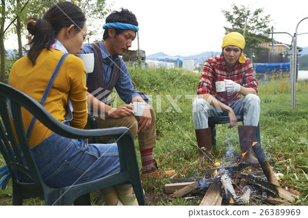 Friends surrounding a bonfire Friends surrounding a bonfire 26389969