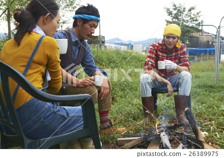 Friends surrounding a bonfire Friends surrounding a bonfire 26389975
