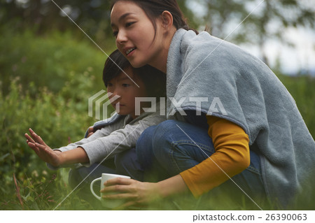 Parent and child holding a hand over a bonfire 26390063