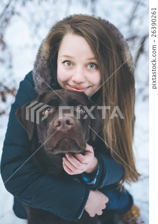 Young woman walking with labrador dog in winter Young woman walking with labrador dog in winter 26390261