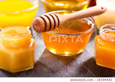 various types of honey in glass jars 26394483