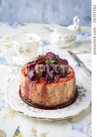 Cheesecake with Plum and Pecan Nut on Plate 26395362