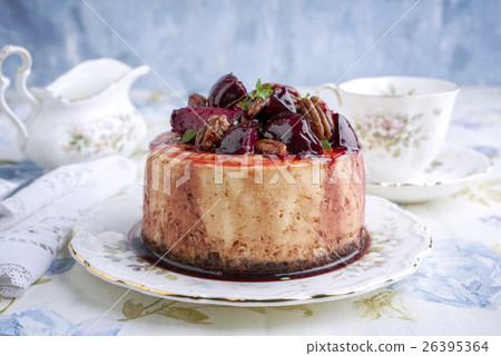 Cheesecake with Plum and Pecan Nut on Plate 26395364