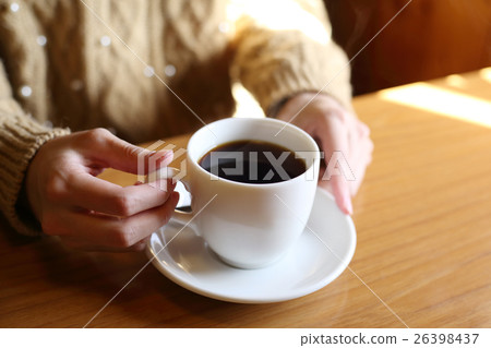 A woman drinking coffee 26398437