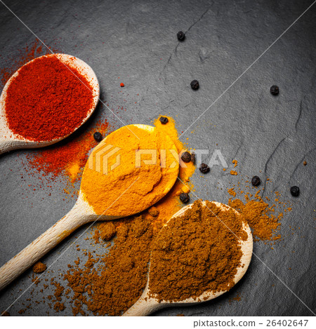 spices in wooden spoons over black spices in wooden spoons over black 26402647