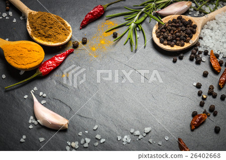 spices and herbs over black stone background spices and herbs over black stone background 26402668
