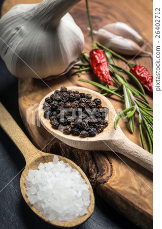 Chili with black pepper and salt on wooden table. 26402712