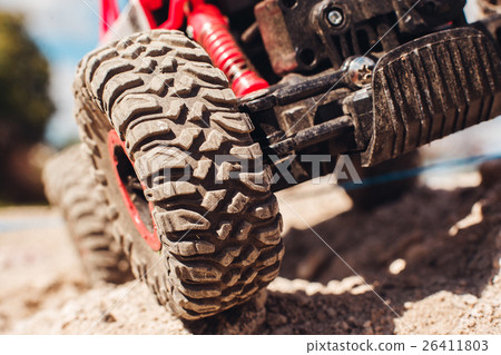 Wheels of off road car on rock landscape, close-up Wheels of off road car on rock landscape, close-up 26411803