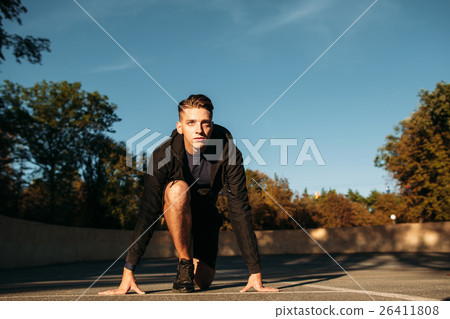 Sprinter standing at the start before race Sprinter standing at the start before race 26411808