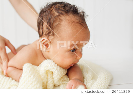 Portrait of baby lying on blanket holding head up Portrait of baby lying on blanket holding head up 26411839