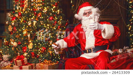 Santa Claus eating cookies and drinking milk on Christmas Santa Claus eating cookies and drinking milk on Christmas 26413309