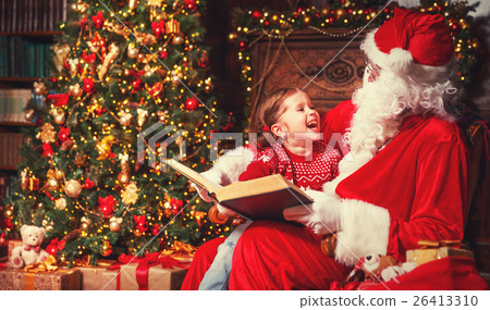 happy child girl with Santa reading book happy child girl with Santa reading book 26413310