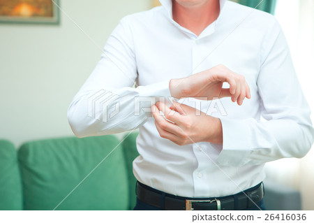 Standing groom in a black tuxedo. Image was taking 26416036