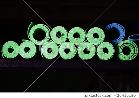 Yoga mats green and blue colors on the shelf. 26416180