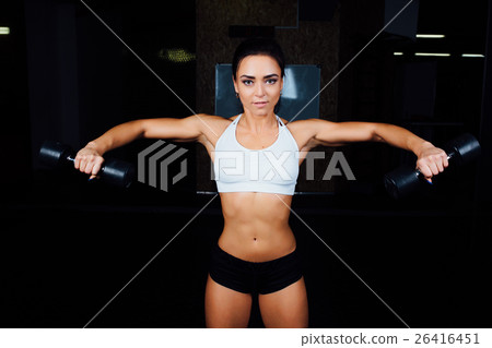 Beautiful fitness woman with lifting dumbbells . Beautiful fitness woman with lifting dumbbells . 26416451