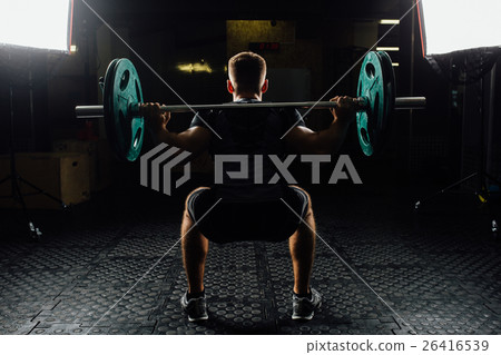 Man training squats with barbells over head. Man training squats with barbells over head. 26416539