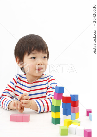 Boy playing with building blocks Boy playing with building blocks 26420536
