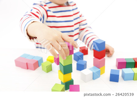 Boy playing with building blocks Boy playing with building blocks 26420539