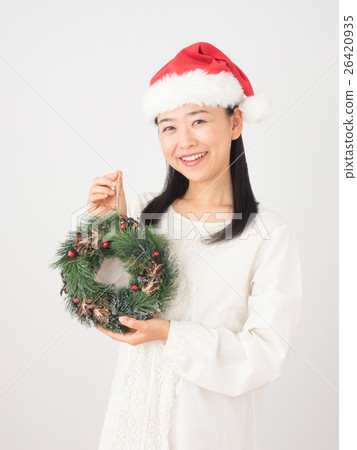 A woman with a Christmas wreath 26420935