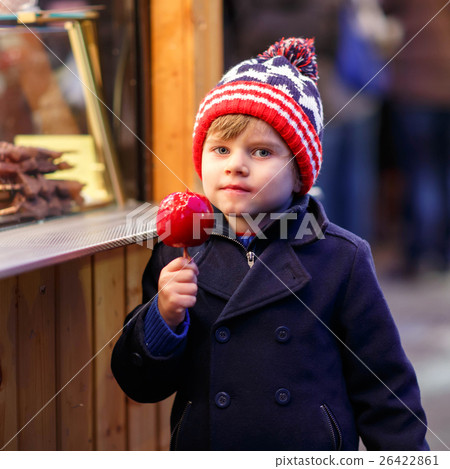 little kid boy eating sweet apple on German little kid boy eating sweet apple on German 26422861
