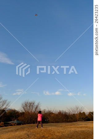 A girl flying a kite A girl flying a kite 26423235